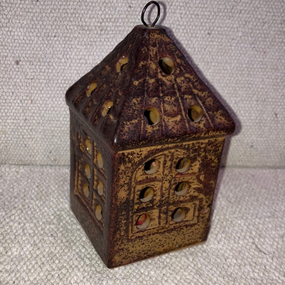 Tea light candle holder in shape of small lantern house
